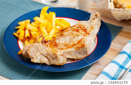 Fried pork tenderloin with potatoes, served with greens Fried pork tenderloin with potatoes, served with greens 138443270