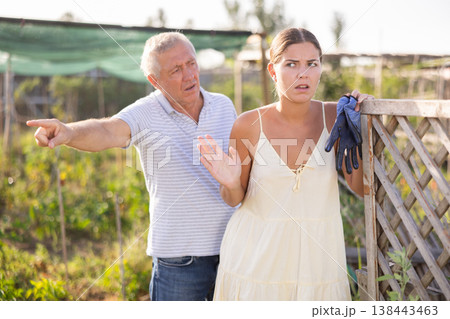 Conflict between neighbors, man and woman, in country farm Conflict between neighbors, man and woman, in country farm 138443463