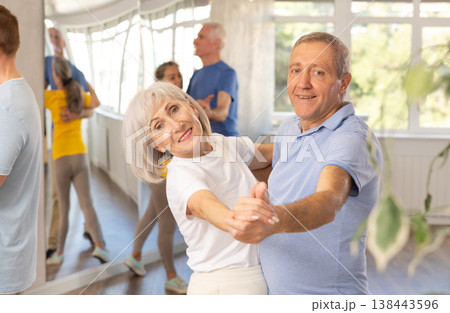 Aged woman and man learning to dance Viennese waltz in dancing class Aged woman and man learning to dance Viennese waltz in dancing class 138443596