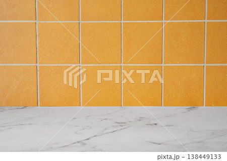 Orange ceramic tiles and empty marble countertop. A minimalist interior design concept 138449133