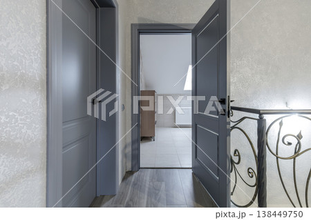 Modern Classic Hallway with Grey Doors and Wrought Iron Railings Modern Classic Hallway with Grey Doors and Wrought Iron Railings 138449750