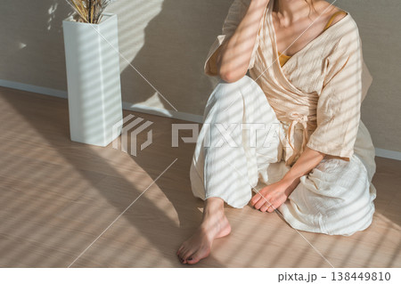 西陽の当たる窓辺にいる女性（モデル,ファッション,光,影） 138449810