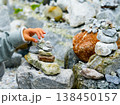 Relaxed spiritually child's hand arrangement pebble tower. Yoga relax meditation 138450157