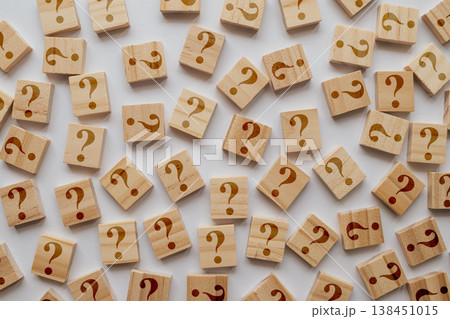 A large collection of wooden tiles with too many question marks. The shallow depth of field emphasizes sea of inquiries and ideas 138451015