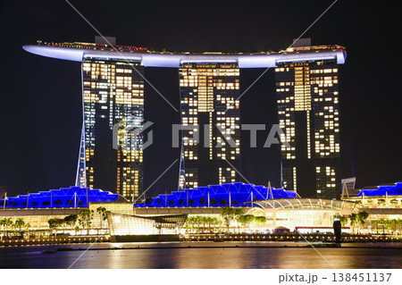 Night view of the Marina Bay Sands. This integrated resort fronts Marina Bay in Singapore. At night, there is an exhilarating music, light, and water dance show. 138451137