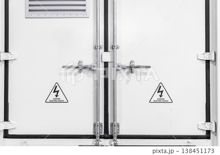 Closed white refrigerated truck door lock. 138451173