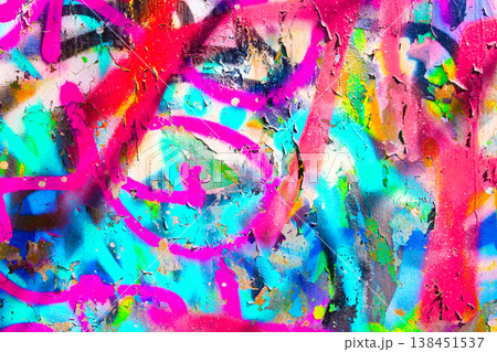 Graffiti on Peeling Paint Wall with Pink Yellow and Blue Textured Surface 138451537