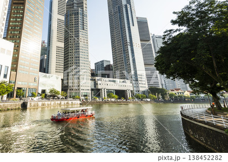Panoramic view of the Sightseeing Bumboats cruising on the Singapore River and the Financial District skyscrapers along the shore. Panoramic view of the Sightseeing Bumboats cruising on the Singapore River and the Financial District skyscrapers along the shore. 138452282