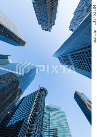 Low-angle building view of the modern office skyscrapers in the financial district of Raffles Place, Singapore. Low-angle building view of the modern office skyscrapers in the financial district of Raffles Place, Singapore. 138452284