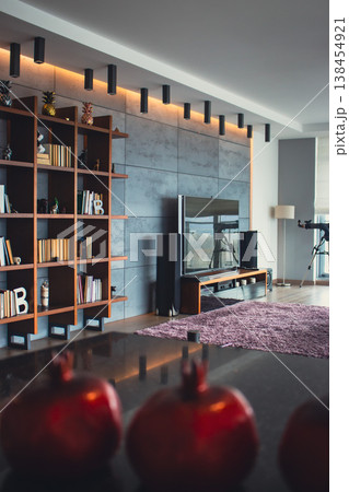 Cozy modern apartment concept. Luxury interior design. Dream house decoration. Wooden bookshelf with books and TV set along the wall. Atmospheric living room design. Home with modern furniture  138454921