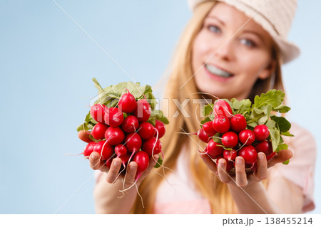 Happy woman giving radish Happy woman giving radish 138455214