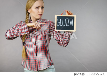 Woman holding board with gluten sign 138455374