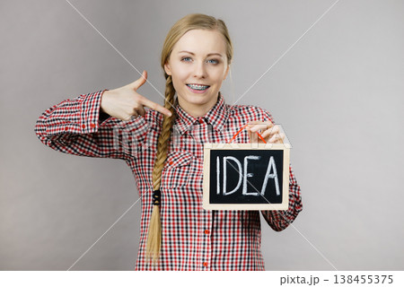 Happy positive woman holding idea sign Happy positive woman holding idea sign 138455375
