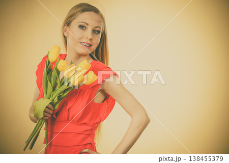 Pretty woman with yellow tulips bunch 138455379