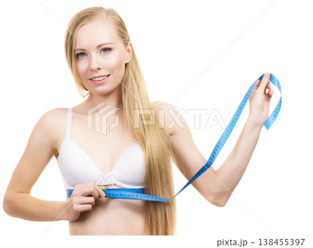 Woman measuring her chest under breast Woman measuring her chest under breast 138455397