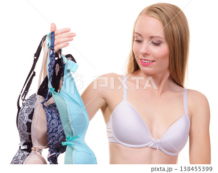 Woman holds bras, choosing 138455399