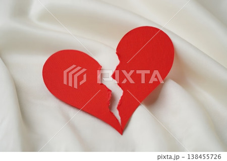 Broken red heart on white textile. divorce concept. Broken red heart on white textile. divorce concept. 138455726