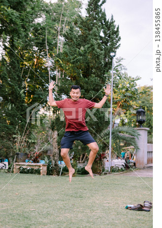 Happy Man Jumping in Red Outfit Celebrating Moment Outdoors Happy Man Jumping in Red Outfit Celebrating Moment Outdoors 138455865