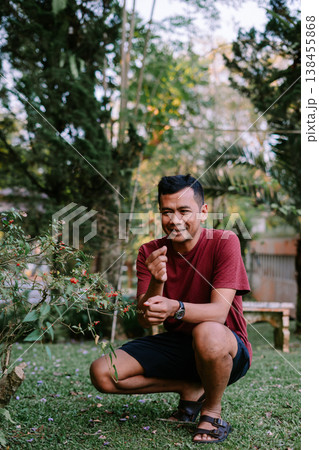 Exploring Nature by Touching Wild Plant with Tiny Red Fruits 138455868