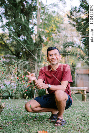 Person Holding Branch with Red Berries in Natural Environment 138455870