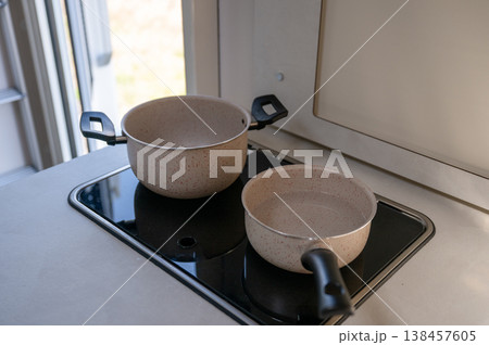 Modern kitchen cookware set with saucepan and pot on electric stove minimalist home cooking concept Modern kitchen cookware set with saucepan and pot on electric stove minimalist home cooking concept 138457605