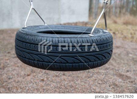Tire swing in playground outdoor leisure activity childhood recreation concept Tire swing in playground outdoor leisure activity childhood recreation concept 138457620