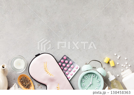 Sleep Wellness Setup with Mask, Pills and Alarm Clock on Soft Background Sleep Wellness Setup with Mask, Pills and Alarm Clock on Soft Background 138458363