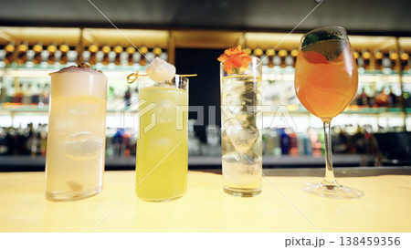 Craft cocktails on bar counter with various garnishes Craft cocktails on bar counter with various garnishes 138459356