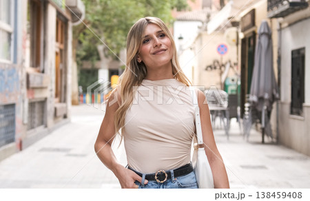 Smiling transgender woman walking on street in old town 138459408