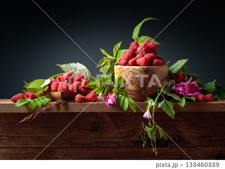 Summer still life with raspberries, meadow grasses and flowers on an old wooden table. Summer still life with raspberries, meadow grasses and flowers on an old wooden table. 138460889