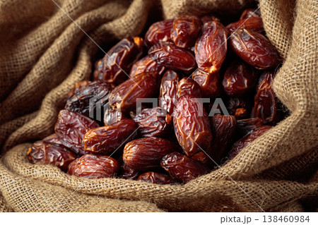 Dates in burlap bag. 138460984