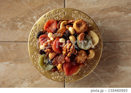Assortment of dried tropical fruits, nuts and raisins. Assortment of dried tropical fruits, nuts and raisins. 138460985