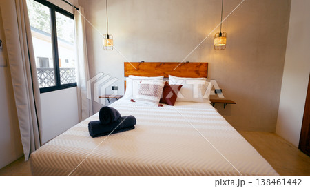 Cozy bedroom interior with wood headboard and warm lighting 138461442