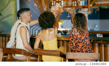 Friends celebrating a happy evening in a tropical bar 138461469