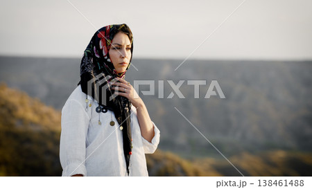 Muslim woman wearing headscarf in desert landscape 138461488