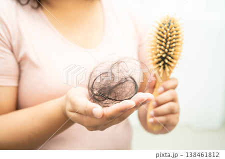 Asian woman have problem with long hair loss attach in her hand. Asian woman have problem with long hair loss attach in her hand. 138461812