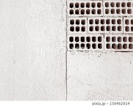 White Painted Wall with Exposed Perforated Bricks White Painted Wall with Exposed Perforated Bricks 138462814