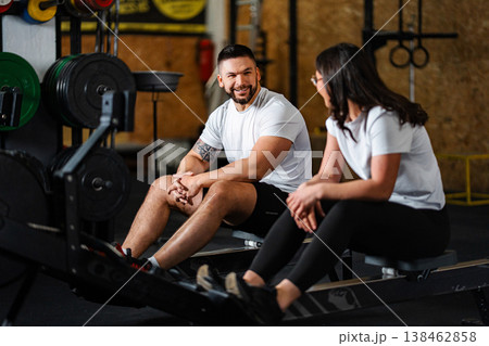 Couple resting and talking together after gym workout Couple resting and talking together after gym workout 138462858
