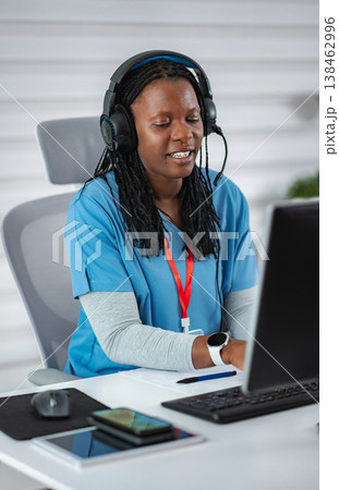 African American woman with headset providing telemedicine service African American woman with headset providing telemedicine service 138462996