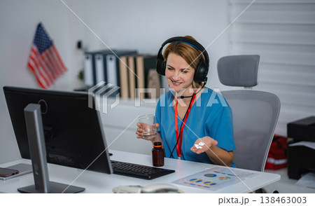 Smiling nurse on a video call helping a patient with prescription pills and water Smiling nurse on a video call helping a patient with prescription pills and water 138463003