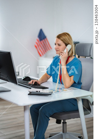 Professional nurse working in medical office with computer and phone Professional nurse working in medical office with computer and phone 138463004