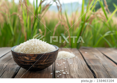 White rice and paddy rice on wooden table. 138463104