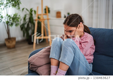Young girl covering ears feeling stress anxiety Young girl covering ears feeling stress anxiety 138463627