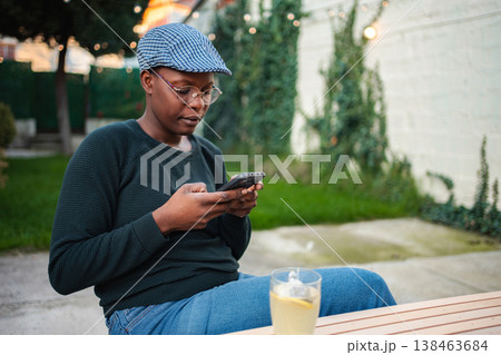 Person using smartphone outdoors communicating relaxing Person using smartphone outdoors communicating relaxing 138463684