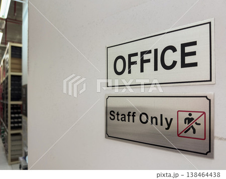Office space signage indicating a restricted area for staff in a professional environment 138464438