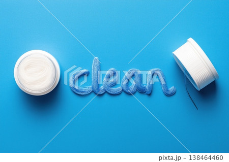 Sparkling clean results achieved with vibrant blue thread art and pristine white spool on azure background Sparkling clean results achieved with vibrant blue thread art and pristine white spool on azure background 138464460