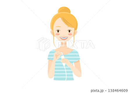 Girl with braces using a specialized oral irrigator 138464609