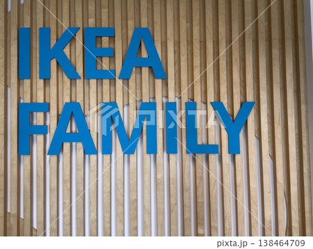 IKEA FAMILY sign against wooden background with blue letters IKEA FAMILY sign against wooden background with blue letters 138464709