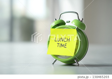 It is lunchtime with green clock and sticky note reminder on the desk for meal, schedule, and break It is lunchtime with green clock and sticky note reminder on the desk for meal, schedule, and break 138465203