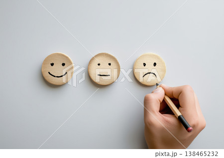 Hand drawing a sad face emoji among neutral and happy expressions for satisfaction survey Hand drawing a sad face emoji among neutral and happy expressions for satisfaction survey 138465232